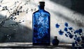 Cobalt blue glass bottle with botanical illustrations on background with textured shadow Royalty Free Stock Photo