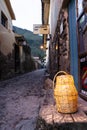 Cobble stone street with lantern sitting on wood stand