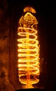 Cobbled classic incandescent Edison light bulbs with visible glowing wires in the night