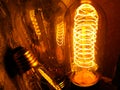 Cobbled classic incandescent Edison light bulbs with visible glowing wires in the night