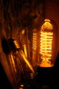 Cobbled classic incandescent Edison light bulbs with visible glowing wires in the night