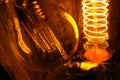 Cobbled classic incandescent Edison light bulbs with visible glowing wires in the night