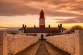 The pathway to the red and white striped, 23 meter tall,  Souter Lighthouse in Marsden, South Shields as the sun rises Royalty Free Stock Photo
