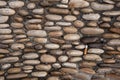 Cobbled pavement made of river rounded pebbles. Background texture.