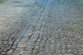 Cobbled road as background. The gray paving stones close up. The texture of the old dark stone. Vintage, grunge. Road surface. Royalty Free Stock Photo