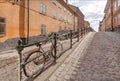 Cobbled stones of of street with city bicycle parked between colorful historical houses. Old area of Stockholm, Sweden. Royalty Free Stock Photo