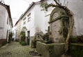 A cobbled street with an antique water fountain in Barroca village