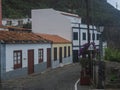 Cobbled street with colorful traditional houses in the village of Agulo located in green valley at north coast. Cloudy