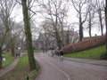 A cobbled street with cyclist by a park in Utrecht, The Netherlands Royalty Free Stock Photo