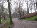 A cobbled street with cyclist by a park in Utrecht, The Netherlands