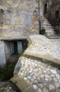 Cobbled street leading sharply upward in the medieval commune town of Calcata in Italy