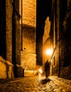 Cobbled street of Old Town with dark blurred silhouette of person. Evokes Jack the Ripper Royalty Free Stock Photo