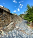 Cobbled street with stone house