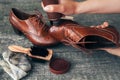 Cobbler holding shoe and applying shoe shiner