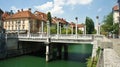 Ljubljana, Slovenia - 07/19/2015 - The Cobbler`s Bridge with Corinthian and Ionic pillars as lamp-bearers, sunny day Royalty Free Stock Photo
