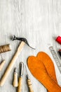 Cobbler takes order. Tools on grey wooden desk background top view copyspace