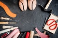 Cobbler tools in workshop dark background top view mock up