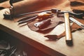 Cobbler tools in workshop on the wooden table . Top view.