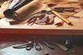 Cobbler tools in workshop on the wooden table . Top view.