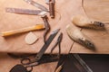 Cobbler tools in workshop on the wooden table . Top view.