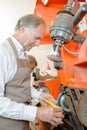 Cobbler using machinery on heel shoe Royalty Free Stock Photo