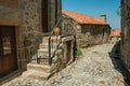 Cobblestone alley on slope and stone old houses Royalty Free Stock Photo