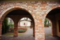 Cobblestone building with an outdoor corridor with arches