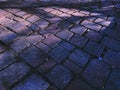 cobblestone dusk evening stone block sidewalk road paver blocks night shadows wet street