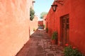 Cobblestone path among red and orange color old buildings in the Monastery of Santa Catalina, Arequipa, Peru Royalty Free Stock Photo