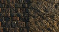 Cobblestone pavement juxtaposed with rough stone surface. The left side features