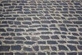 Cobblestone road. Old road paved with stones. Close-up. Copy space Royalty Free Stock Photo