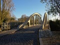 Cobblestone road over old tied arch bridge in Drongen, Flanders Royalty Free Stock Photo