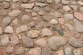 Cobblestone road in the sand. Fragment of paving stones. Background. Royalty Free Stock Photo