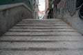 Cobblestone steps leading into an empty alleyway in daytime