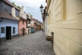 Cobblestone street and colorful 16th century cottages of artisans known as Golden Lane inside the castle walls Prague Czech Re Royalty Free Stock Photo