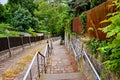 A cobblestone street with a fence and stairs with railings going down the street in Germany Royalty Free Stock Photo