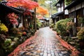 a cobblestone street lined with colorful autumn leaves