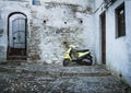 Cobblestone Street with Parked Scooter, Granada Royalty Free Stock Photo