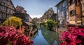 Cobblestone street in picturesque Alsace village with half timbered houses and beautiful flowers. Royalty Free Stock Photo