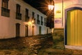 Cobblestone street and reflections in puddles in the historic city of Paraty