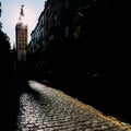 Cobblestone street with Seville Cathedral Gothic-Moorish Giralda Bell Tower, Seville, Spain