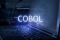 Cobol inscription against laptop and code background. Technology concept Royalty Free Stock Photo