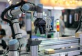 Cobot (Collaborative Robot) with electric gripper and sensor in automation line.