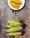 Cobs fresh corn on old wooden surface Royalty Free Stock Photo