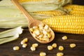 Cobs of ripe corn with grains of corn on a wooden background Royalty Free Stock Photo