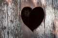 Cobweb in heart shaped hole in old outhouse wooden door Royalty Free Stock Photo