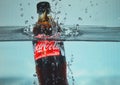 Coca Cola bottle splashing into the water Royalty Free Stock Photo