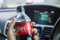 Coke zero no sugar in a driver hand,Coca cola brand