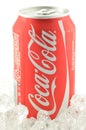 Coca-Cola drink in a can on ice isolated on white background. Royalty Free Stock Photo