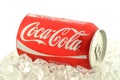 Coca-Cola drink in a can on ice isolated on white background. Royalty Free Stock Photo